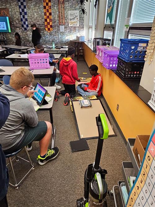 6th grade programs their robots. 